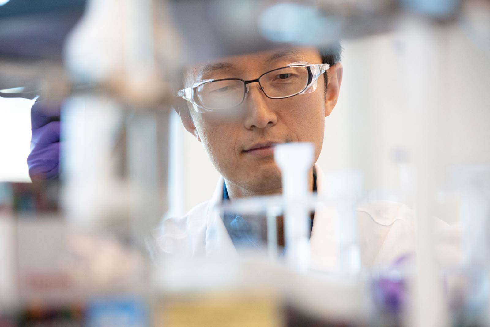 Scientist reviewing test tubes