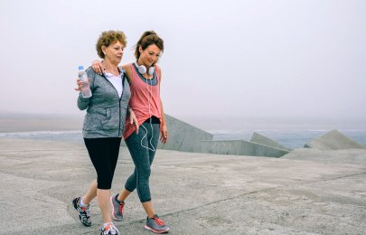 two women walking on beach