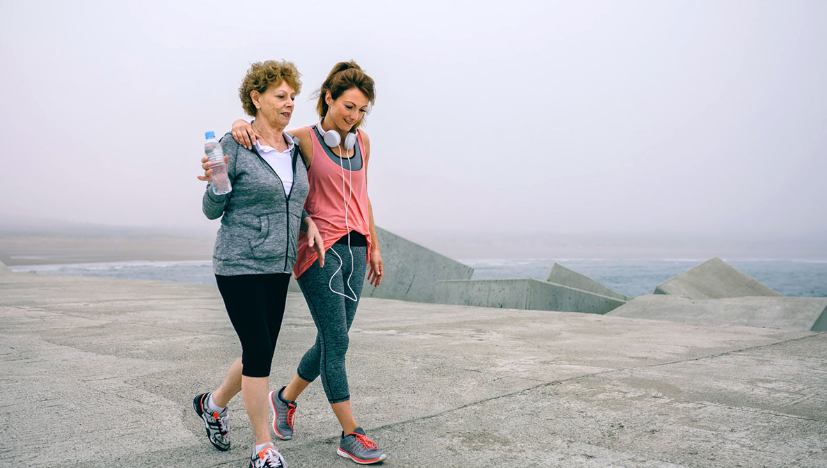 two women walking on beach