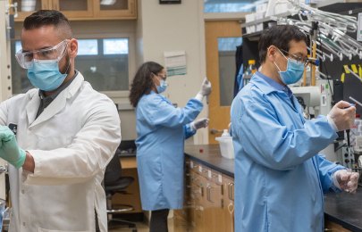 scientists wearing masks working in a lab
