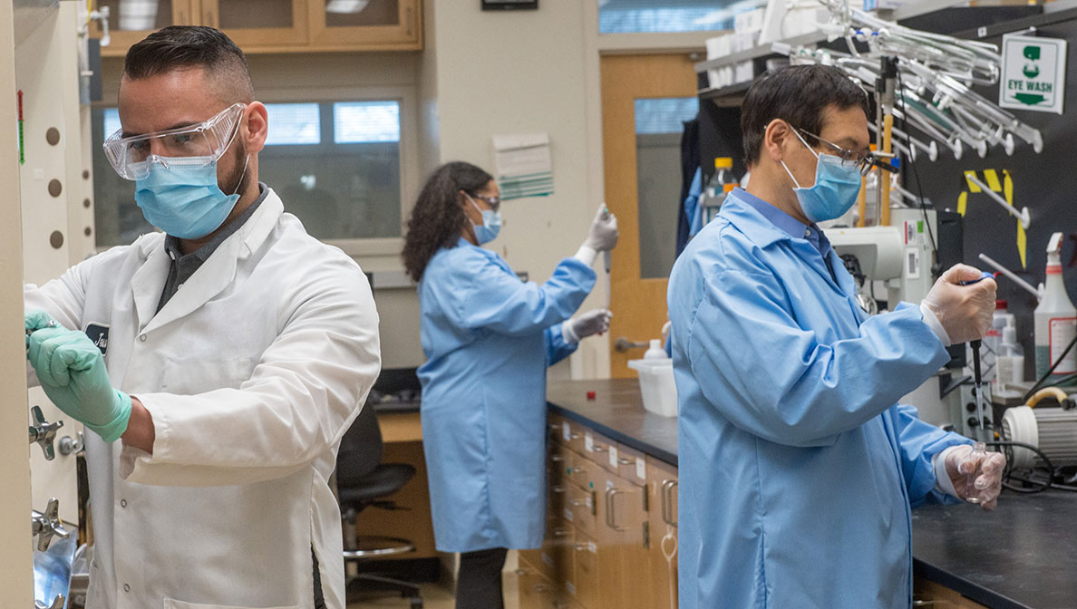 scientists wearing masks working in a lab