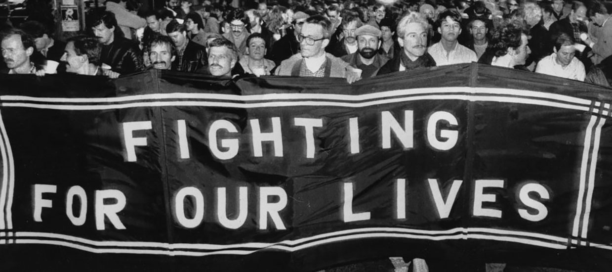 group of people marching with large fighting for our lives banner