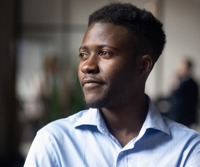 Black man looking out window