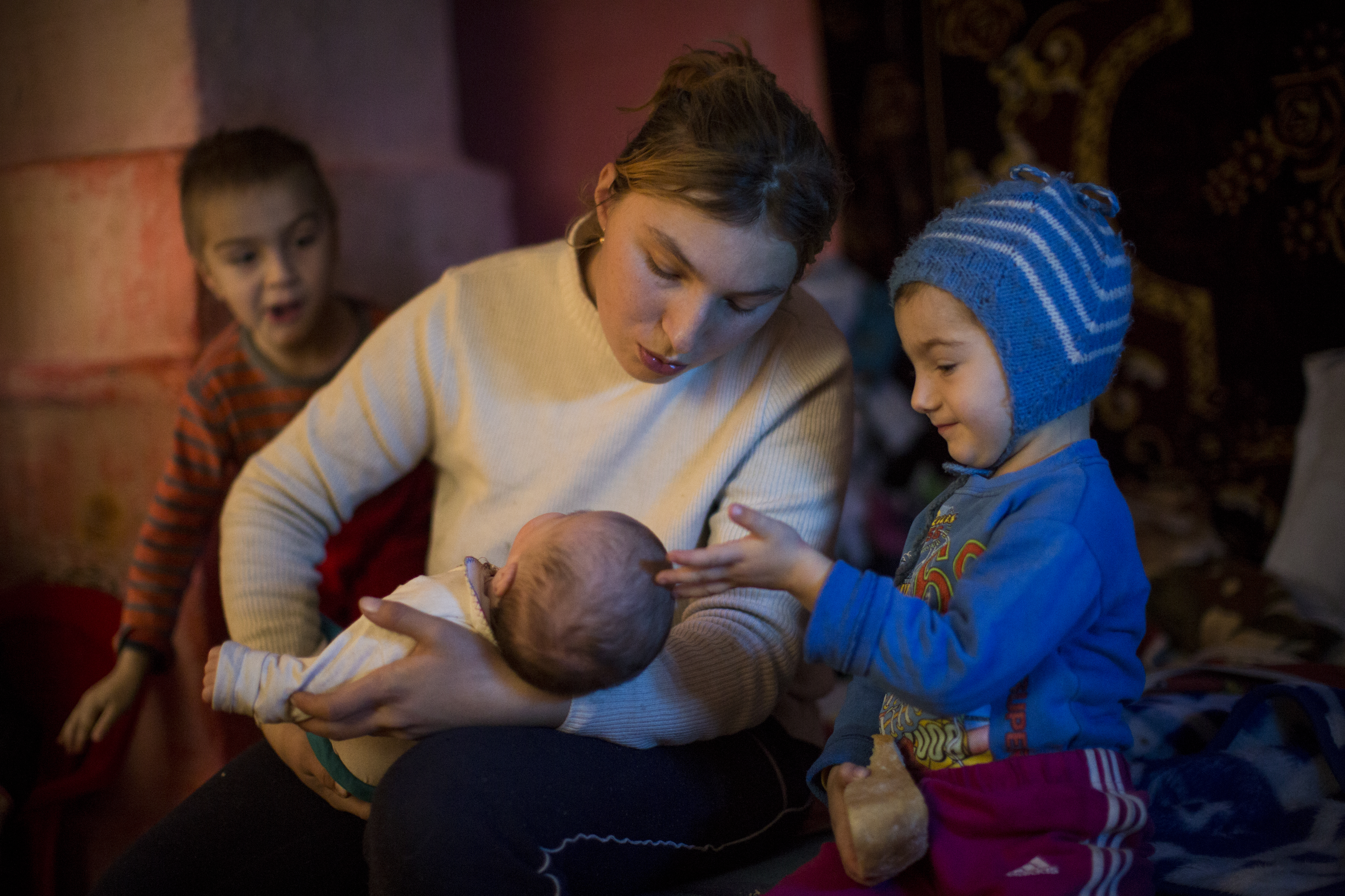 Mother with her baby and toddler in Romania