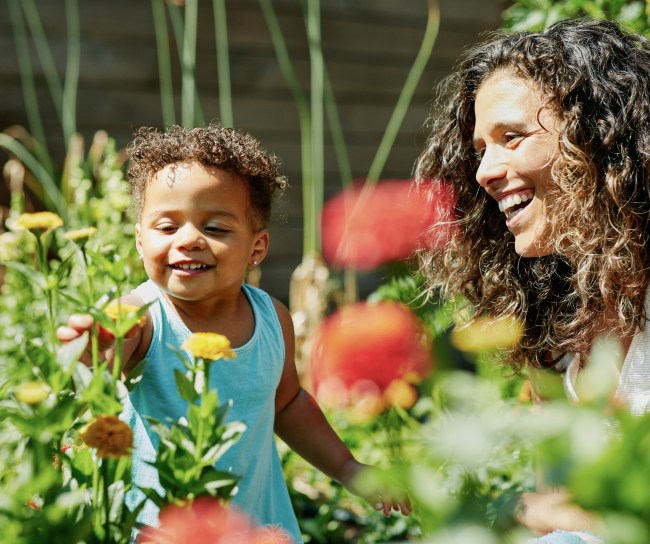 woman and child smiling in a garden
