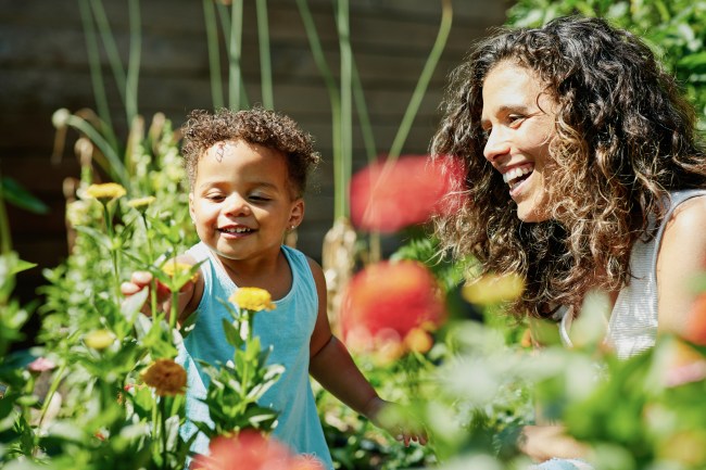 woman and child smiling in a garden