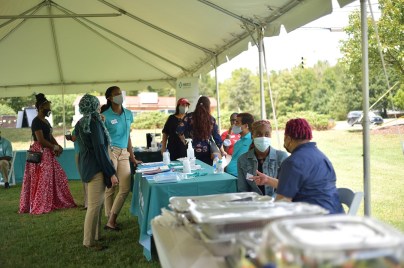 diverse employees outside in tent