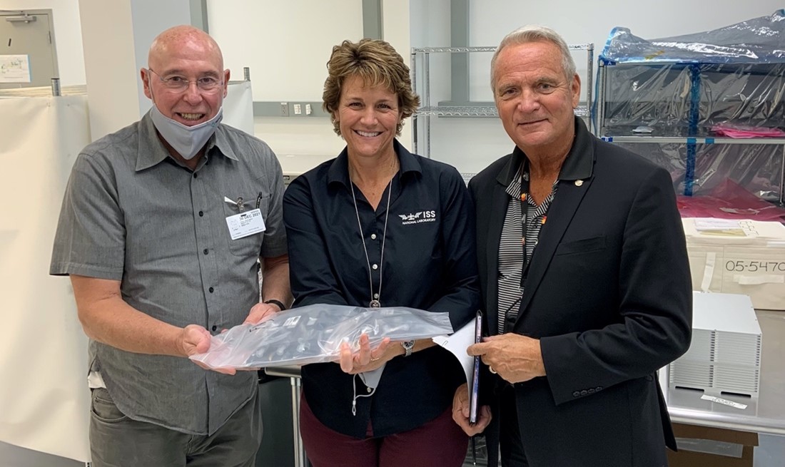 Paul Reichert joins April Spinale and Raymond Polniak of CASIS to inspect the experiment