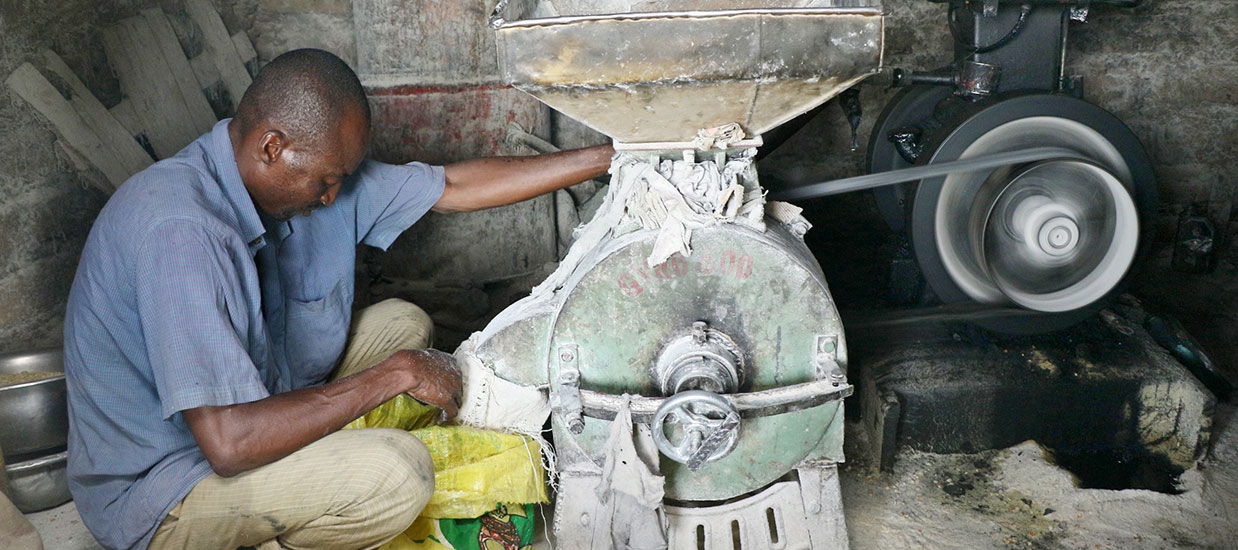 Farmer milling grain for storage
