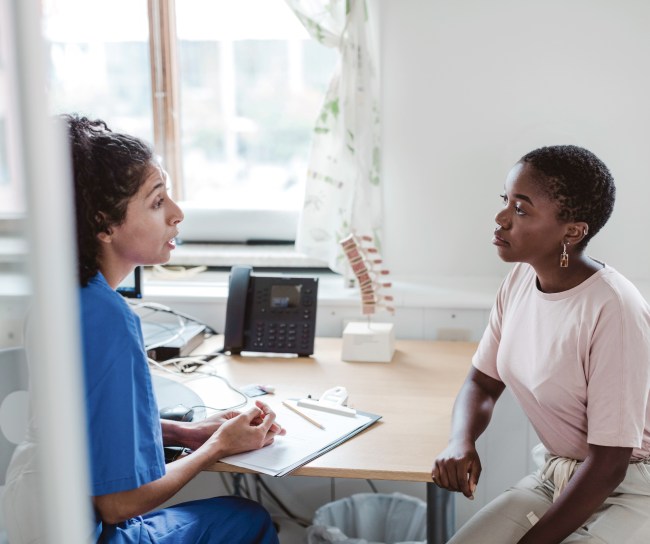 Woman patient talking with health care provier