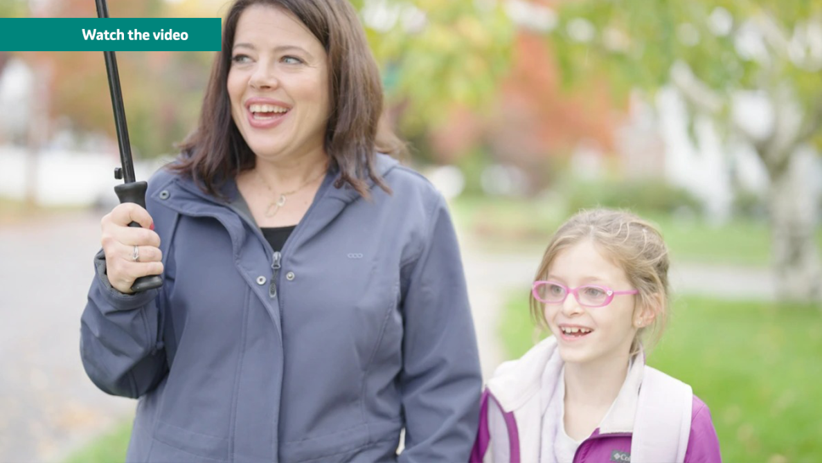 mother holding an umbrella walking her child