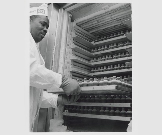 scientist taking out trey of vial