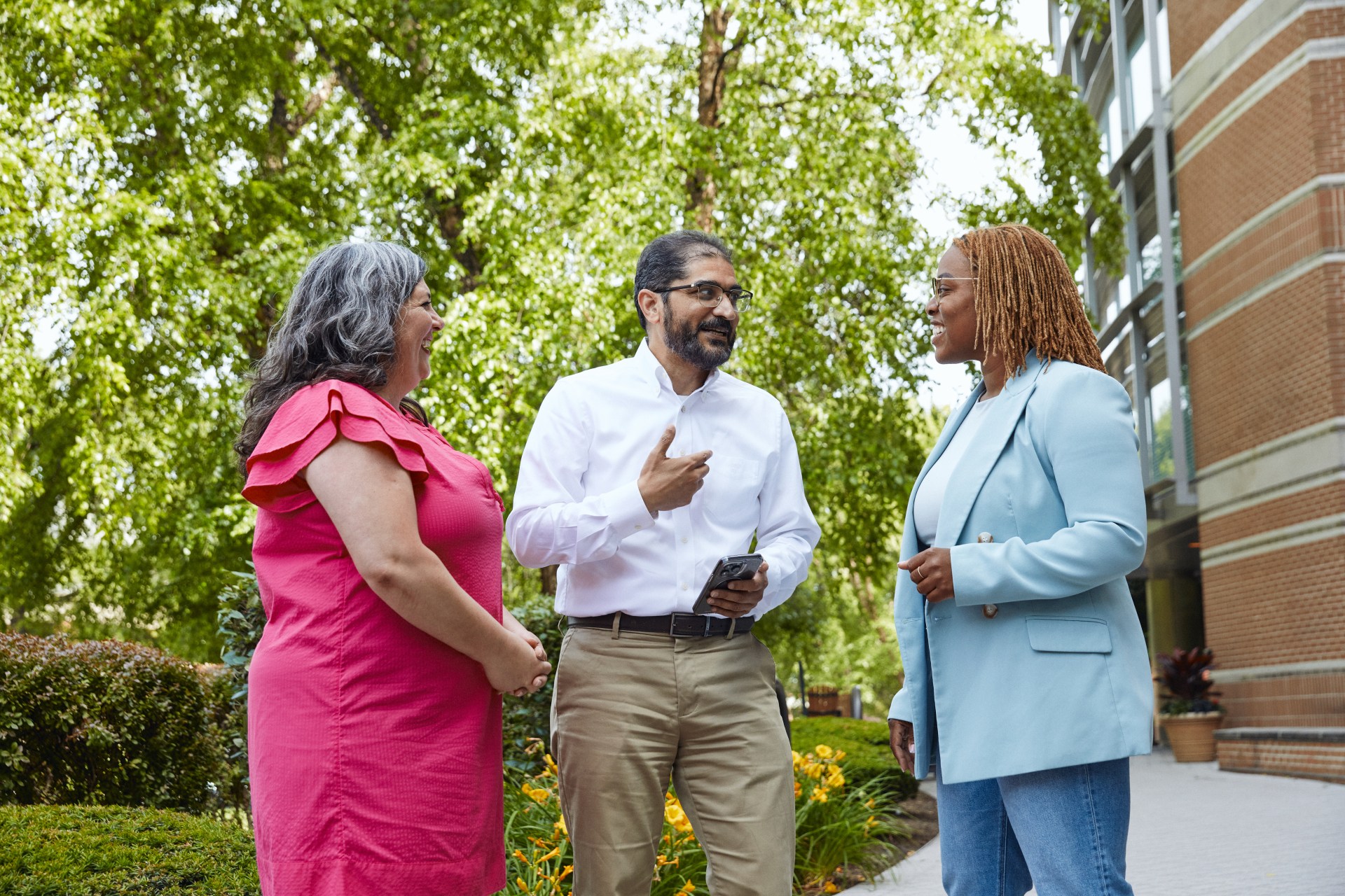 two women and a man talking