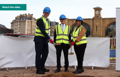 3 people with hard hats breaking ground