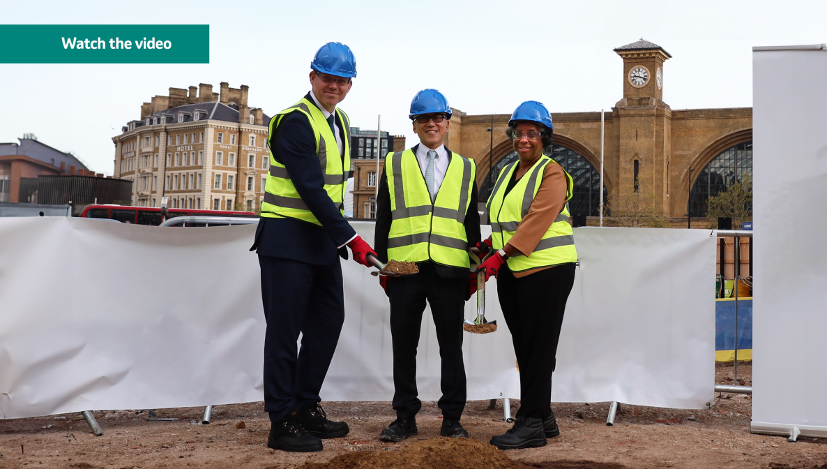 3 people with hard hats breaking ground