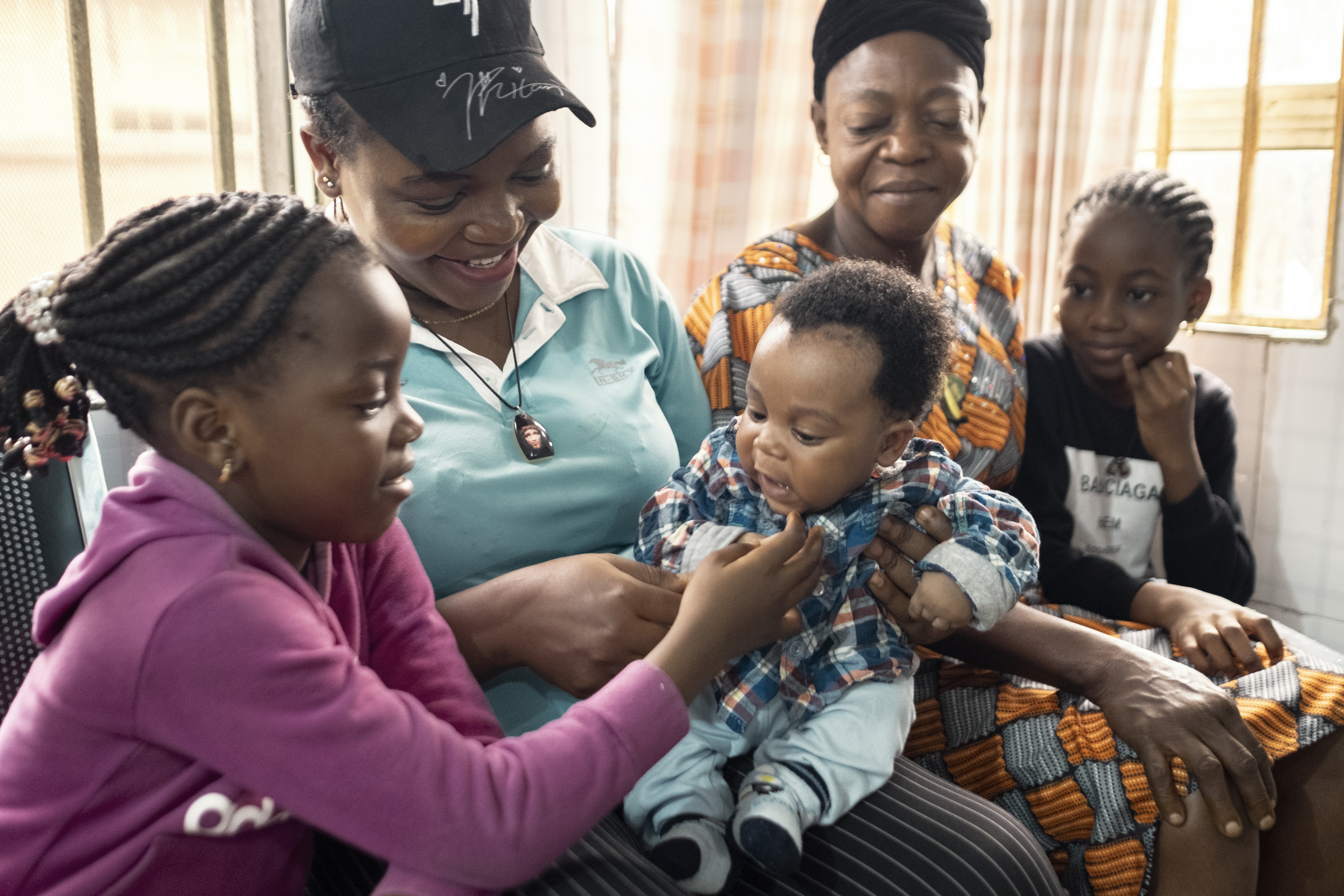 women smiling with children