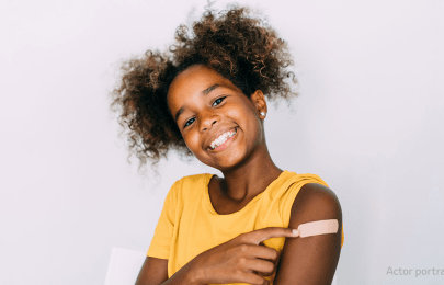 smiling child with band aid on her arm