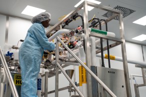 Scientist on steps adjusting equipment