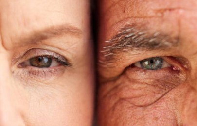 Close-up of two eyes side by side, showing contrast in skin tone and eye color between two individuals.