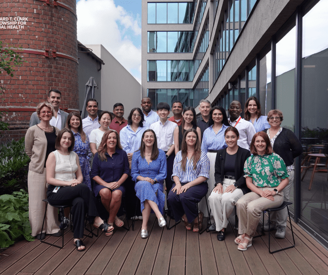 Group of more than 20 people smiling for the photo
