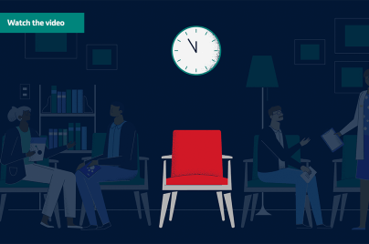 Red chair with clock above it and shadows of patients in the background